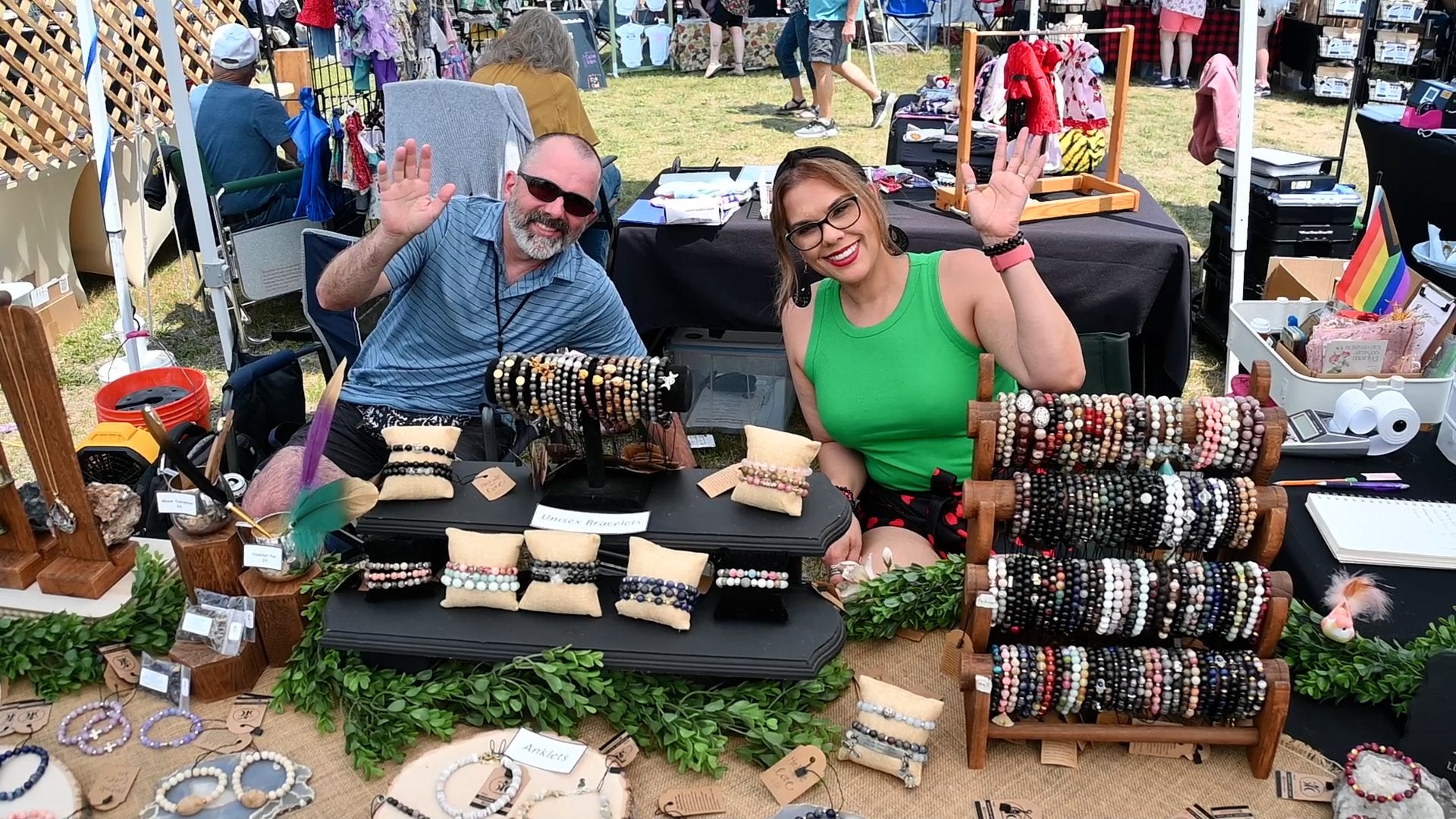Two jewelry vendors welcome shoppers at a Countryside Village outdoor market
