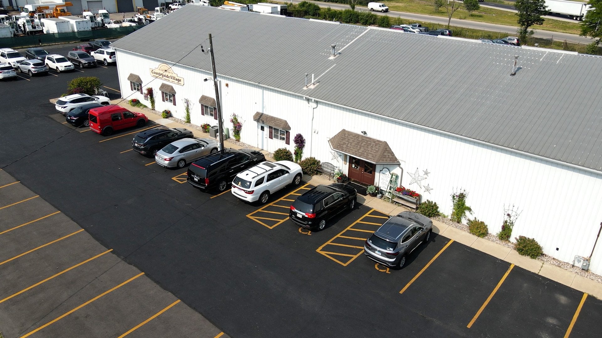 Countryside Village storefront with parking and seasonal planters